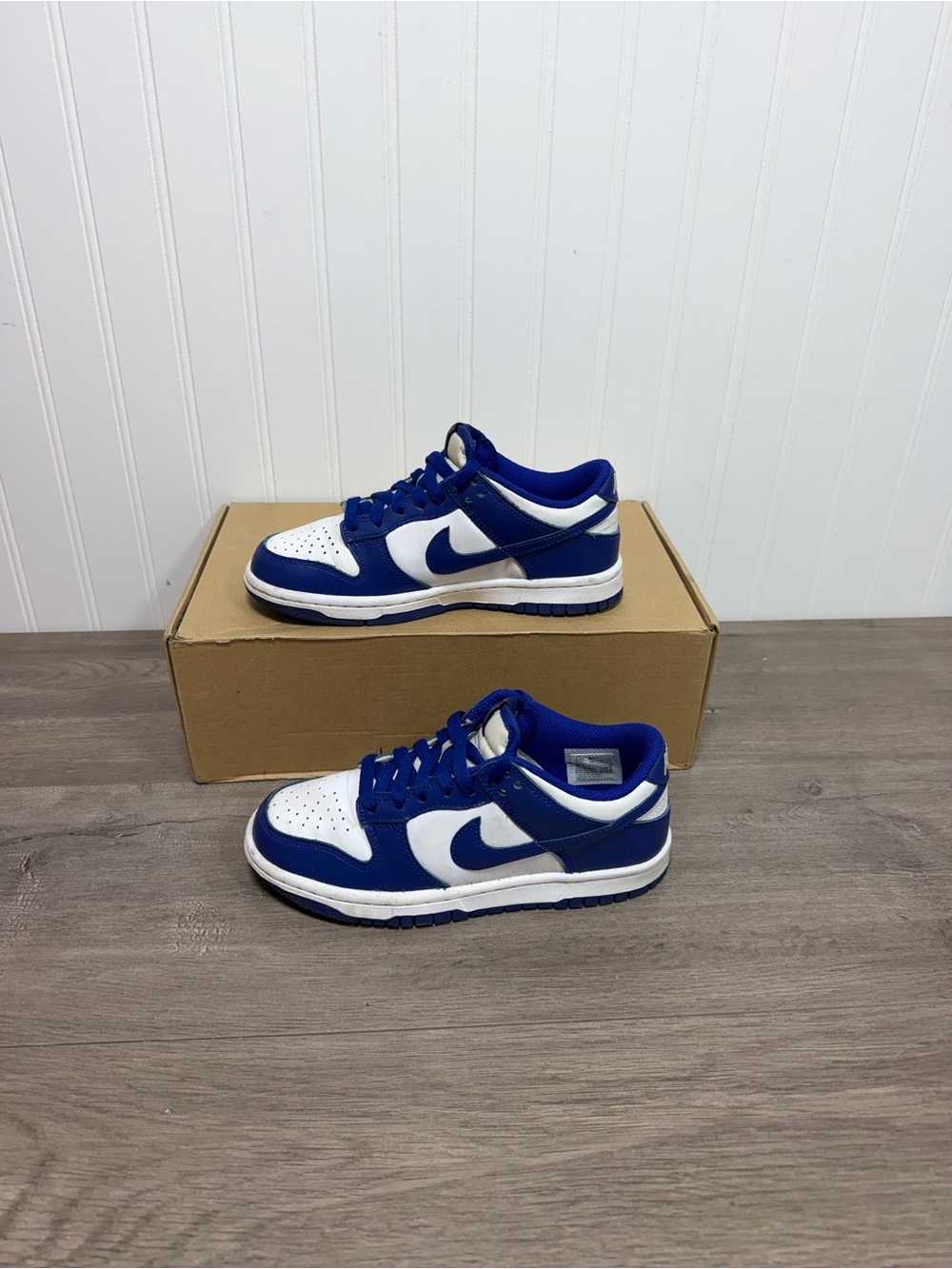 Used kids Nike Dunk Low sneakers in a white and royal blue size 3.5